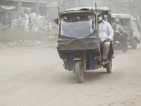 Commuters make their way amid unhealthy air quality in Dhaka, Bangladesh, on December 1, 2024. (