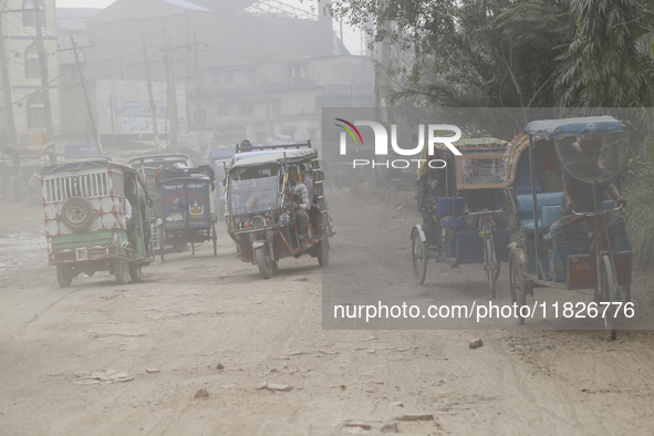 Commuters make their way amid unhealthy air quality in Dhaka, Bangladesh, on December 1, 2024. 