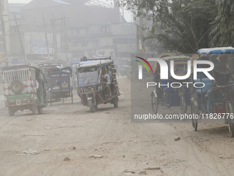 Commuters make their way amid unhealthy air quality in Dhaka, Bangladesh, on December 1, 2024. (