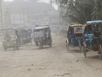 Commuters make their way amid unhealthy air quality in Dhaka, Bangladesh, on December 1, 2024. (