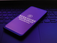 The Berkshire Hathaway HomeServices logo appears on the screen of a smartphone in Reno, United States, on December 1, 2024. (