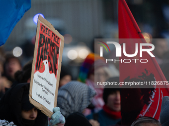 More than a hundred pro-Palestinian protesters take part in a demonstration against the German government's supply of arms to Israel in Colo...