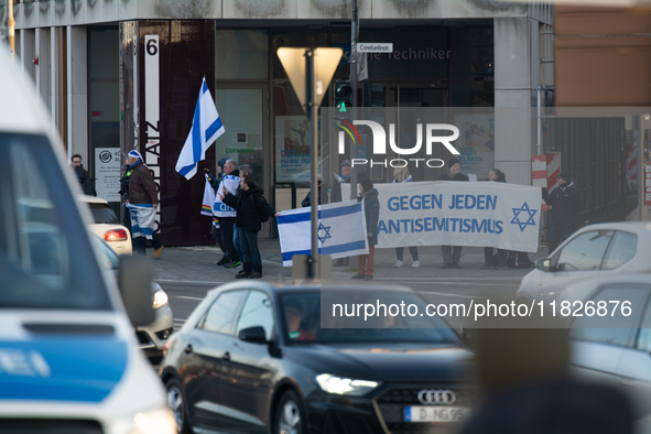 A dozen counter-protesters cross the street as more than a hundred pro-Palestinian protesters take part in a demonstration against the Germa...