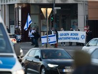 A dozen counter-protesters cross the street as more than a hundred pro-Palestinian protesters take part in a demonstration against the Germa...