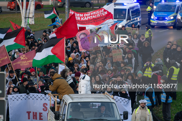 More than a hundred pro-Palestinian protesters take part in a demonstration against the German government's supply of arms to Israel in Colo...