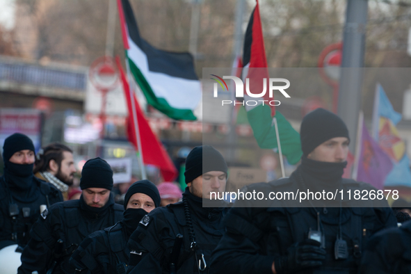 Police walk alongside protesters as more than a hundred pro-Palestinian protesters participate in a demonstration against the German governm...