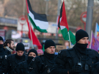 Police walk alongside protesters as more than a hundred pro-Palestinian protesters participate in a demonstration against the German governm...