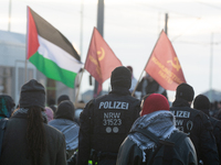 Police walk alongside protesters as more than a hundred pro-Palestinian protesters participate in a demonstration against the German governm...