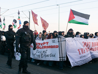 Police walk alongside protesters as more than a hundred pro-Palestinian protesters participate in a demonstration against the German governm...