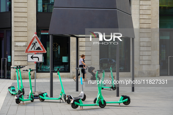 Rental e-scooters park in a pedestrian zone in Hamburg, Germany, on August 26, 2022. A cluster of bright green rental e-scooters is in a ped...