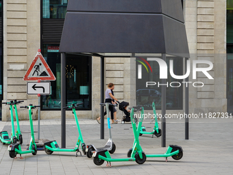 Rental e-scooters park in a pedestrian zone in Hamburg, Germany, on August 26, 2022. A cluster of bright green rental e-scooters is in a ped...