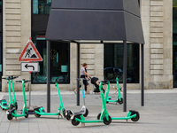 Rental e-scooters park in a pedestrian zone in Hamburg, Germany, on August 26, 2022. A cluster of bright green rental e-scooters is in a ped...