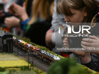 KRAKOW, POLAND - DECEMBER 01: 
Train enthusiasts and hobbyists gather at the Nowa Huta Cultural Center, where a 700 m2 space becomes a capti...