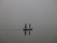 A man rows a boat in the waters of Dal Lake amid fog in Srinagar, Jammu and Kashmir, on December 02, 2024. Weather experts warn of heavy sno...