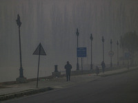 People jog on the banks of Dal Lake amid fog in Srinagar, Jammu and Kashmir, on December 02, 2024. Weather experts warn of heavy snowfall an...