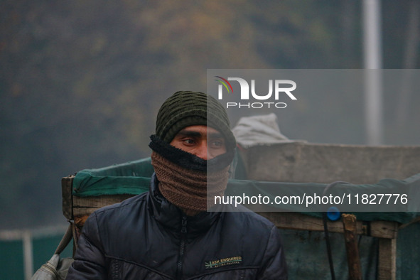 A man looks on amid fog in Srinagar, Jammu and Kashmir, on December 02, 2024. Weather experts warn of heavy snowfall and a harsh winter in J...