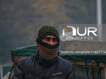 A man looks on amid fog in Srinagar, Jammu and Kashmir, on December 02, 2024. Weather experts warn of heavy snowfall and a harsh winter in J...