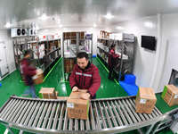 A worker at a cold storage for smart vaccines takes stock of vaccines on the shelves in Guiyang, Guizhou province, China, on December 2, 202...