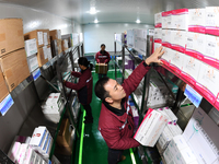 A staff member of a cold storage for smart vaccines takes stock of vaccines on shelves in Guiyang, China, on December 2, 2024. (