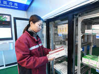 A staff member at a cold storage for smart vaccines checks vaccine information in Guiyang, China, on December 2, 2024. (