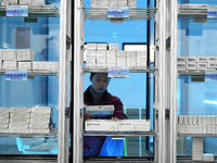 A staff member at a cold storage for smart vaccines checks vaccine information in Guiyang, China, on December 2, 2024. (