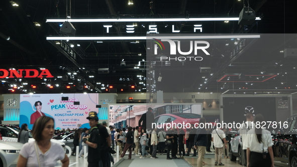 Visitors inspect Tesla cars displayed at the Thailand International Motor Expo 2024 at the IMPACT exhibition center in Bangkok, Thailand, on...