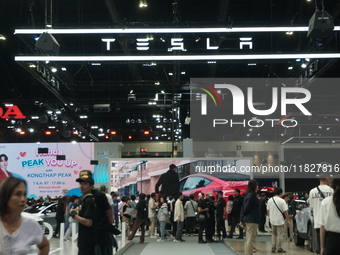 Visitors inspect Tesla cars displayed at the Thailand International Motor Expo 2024 at the IMPACT exhibition center in Bangkok, Thailand, on...