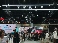 Visitors inspect Tesla cars displayed at the Thailand International Motor Expo 2024 at the IMPACT exhibition center in Bangkok, Thailand, on...