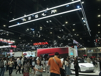 Visitors inspect Tesla cars displayed at the Thailand International Motor Expo 2024 at the IMPACT exhibition center in Bangkok, Thailand, on...