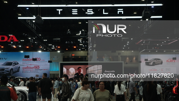 Visitors inspect Tesla cars displayed at the Thailand International Motor Expo 2024 at the IMPACT exhibition center in Bangkok, Thailand, on...