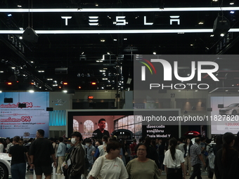 Visitors inspect Tesla cars displayed at the Thailand International Motor Expo 2024 at the IMPACT exhibition center in Bangkok, Thailand, on...