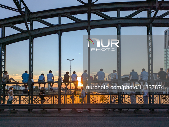 Young people gather on the Hackerbrucke in Munich, Bavaria, to view the sunset, on september 07, 2024.This bridge, which connects the centra...