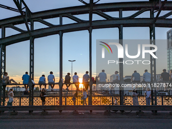 Young people gather on the Hackerbrucke in Munich, Bavaria, to view the sunset, on september 07, 2024.This bridge, which connects the centra...