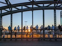 Young people gather on the Hackerbrucke in Munich, Bavaria, to view the sunset, on september 07, 2024.This bridge, which connects the centra...