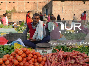 A man stands at his makeshift vegetable shop at a temporary open-air market in Samastipur, Bihar, India, on november 29, 2024.(