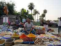 A man sells loose spices at a temporary open-air market in Samastipur, Bihar, India on november 29, 2024.(