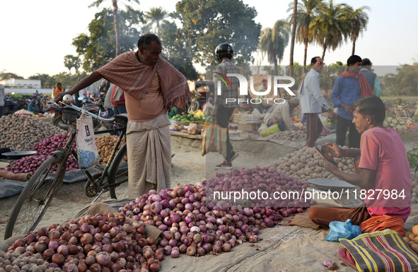 A customer looks at onions at a temporary open-air vegetable market in Samastipur, Bihar, India. on november 29, 2024.