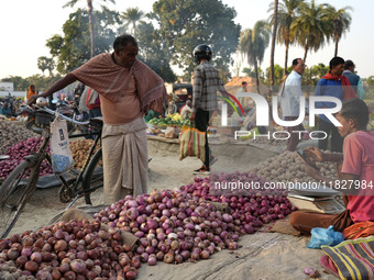 A customer looks at onions at a temporary open-air vegetable market in Samastipur, Bihar, India. on november 29, 2024.(