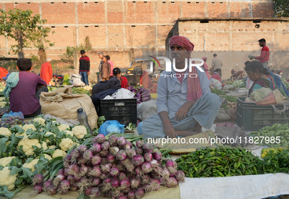 A man sells vegetables at a temporary open-air market and waits for customers in Samastipur, Bihar, India on november 29, 2024.