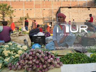 A man sells vegetables at a temporary open-air market and waits for customers in Samastipur, Bihar, India on november 29, 2024.(