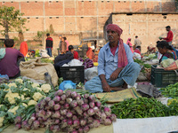 A man sells vegetables at a temporary open-air market and waits for customers in Samastipur, Bihar, India on november 29, 2024.(