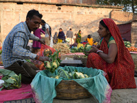 A couple sets up their vegetable shop at a temporary open-air market in Samastipur, Bihar, India. on november 29, 2024.(