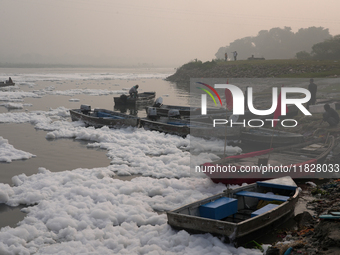 Boats in the Yamuna River are covered in toxic foam in New Delhi, India, on November 7, 2024. (