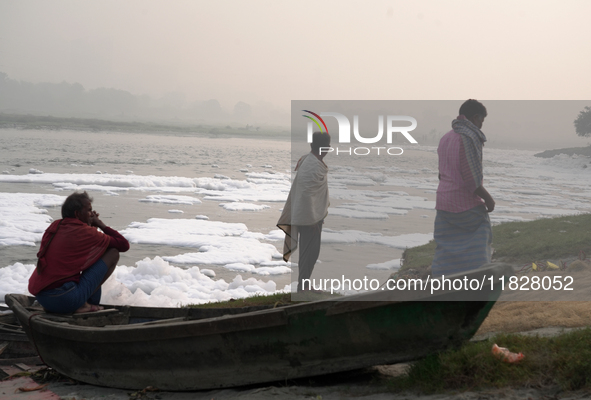 Fishermen sit on the bank of the Yamuna River filled with toxic foam in New Delhi, India, on November 7, 2024. 