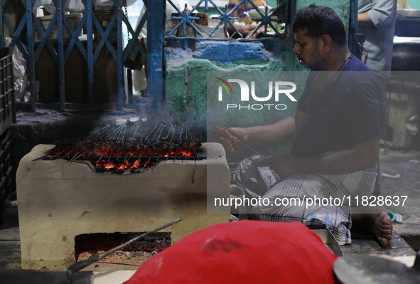 A street vendor grills chicken kebabs at his roadside stall in Kolkata, India, on December 02, 2024. Consumer price inflation in India climb...