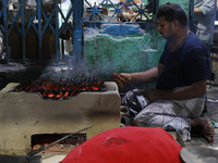 A street vendor grills chicken kebabs at his roadside stall in Kolkata, India, on December 02, 2024. Consumer price inflation in India climb...