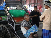 Hand-pulled rickshaw pullers wait for passengers at a roadside stall in Kolkata, India, on December 02, 2024. (