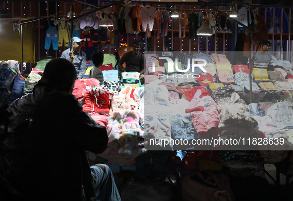 Vendors wait for customers at their roadside cloth stalls in Kolkata, India, on December 02, 2024. 