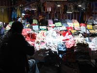 Vendors wait for customers at their roadside cloth stalls in Kolkata, India, on December 02, 2024. (