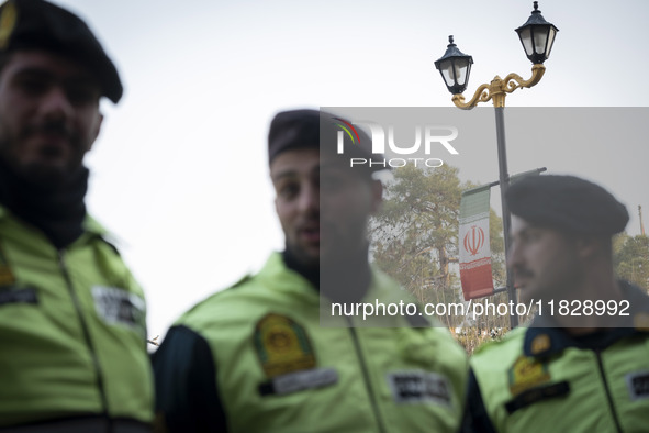 Iranian policemen stand guard outside the Turkish embassy during a protest against Turkish President Recep Tayyip Erdogan and his diplomacy...